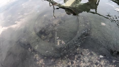 Old-tire-as-rubbish-in-sea-water.